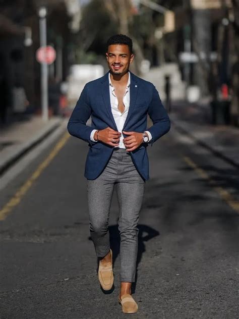 blue blazer with grey trousers.